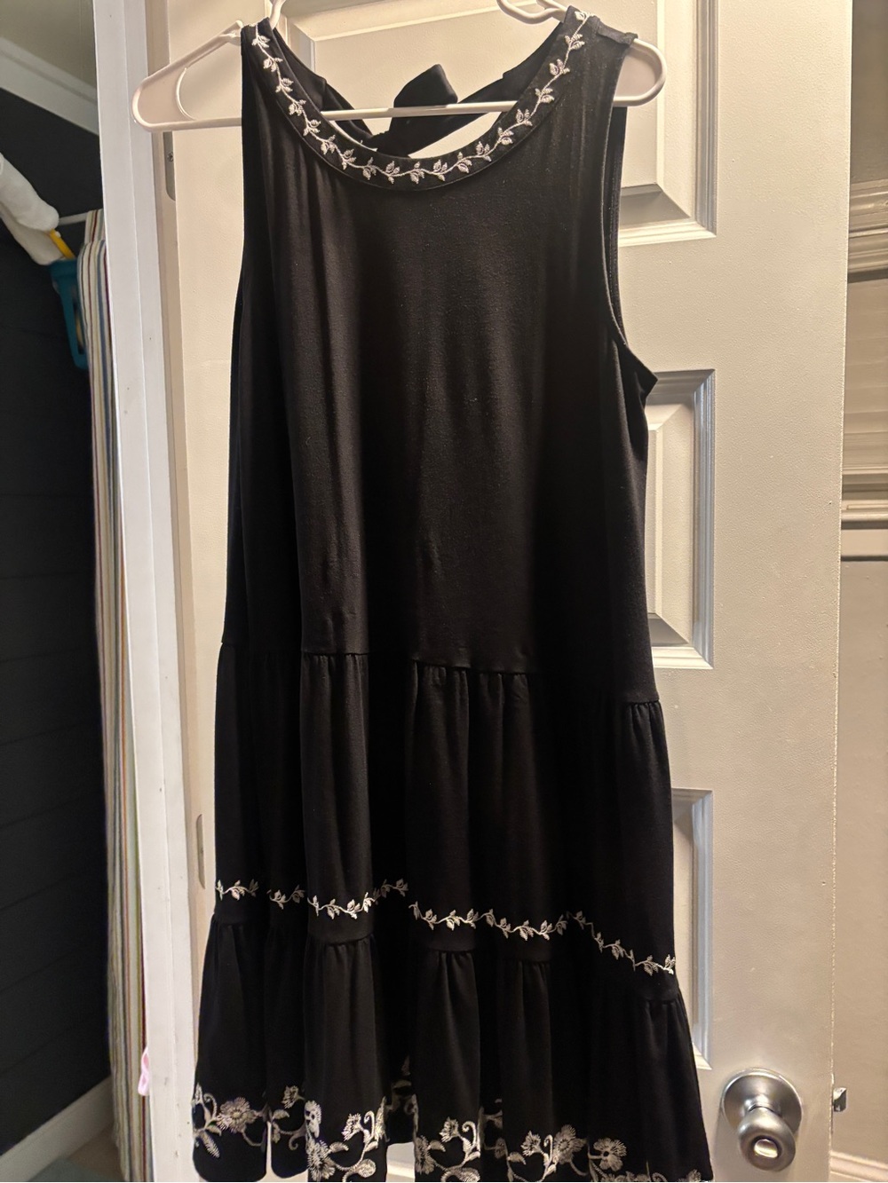 Loft Dress: black sleeveless with tie back and embroidered neckline